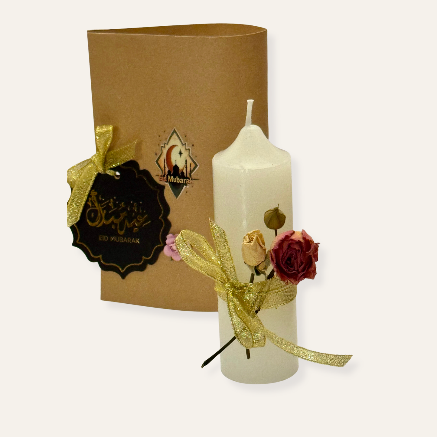 Decorative candle with flowers and a brown gift box on a white background