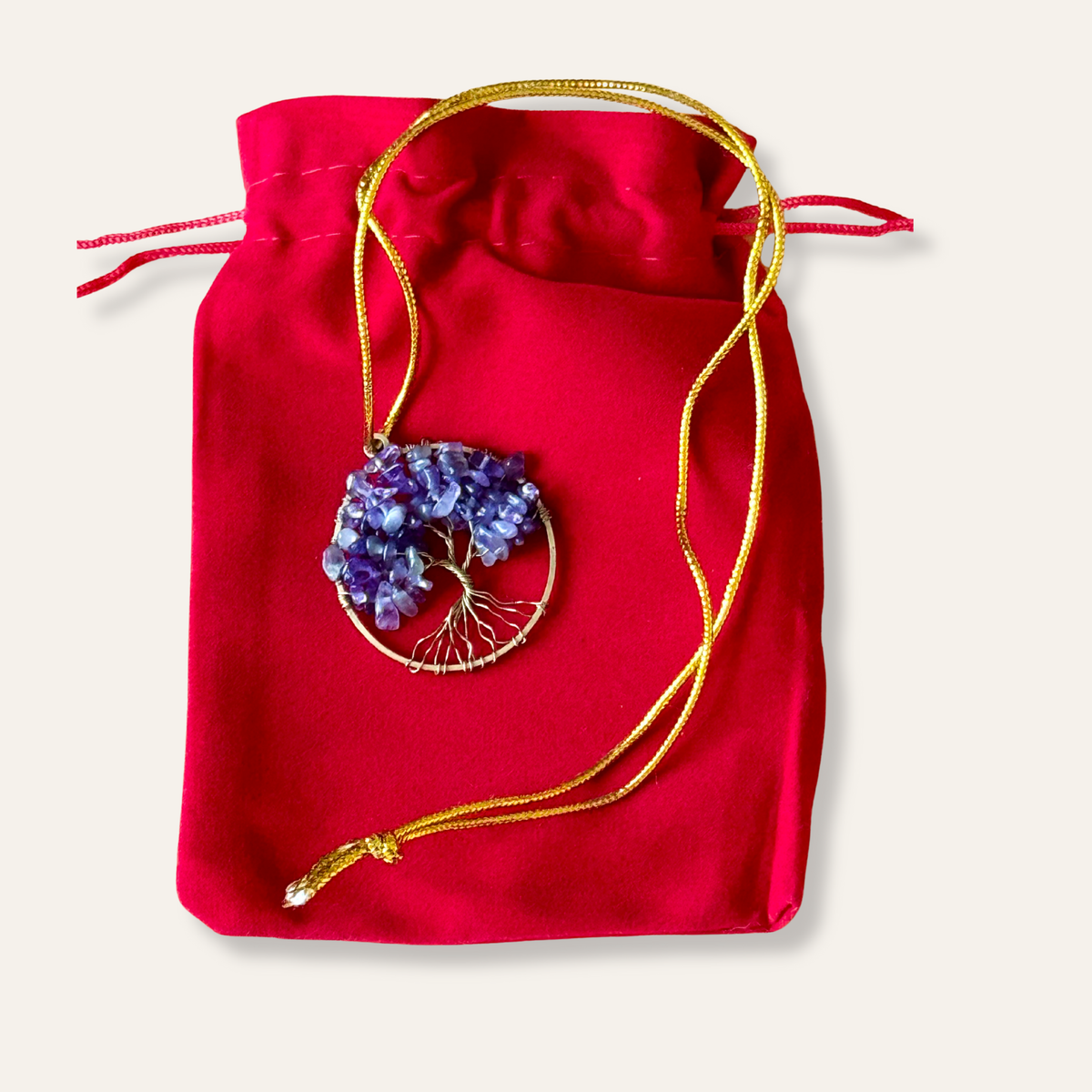 Jewelry with amethyst stones Tree of Life on a red drawstring bag
