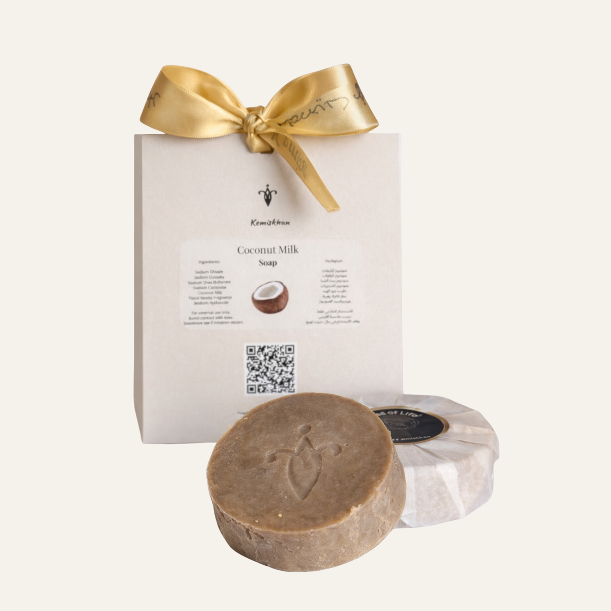 Coconut milk soap with packaging featuring a gold bow on a white background