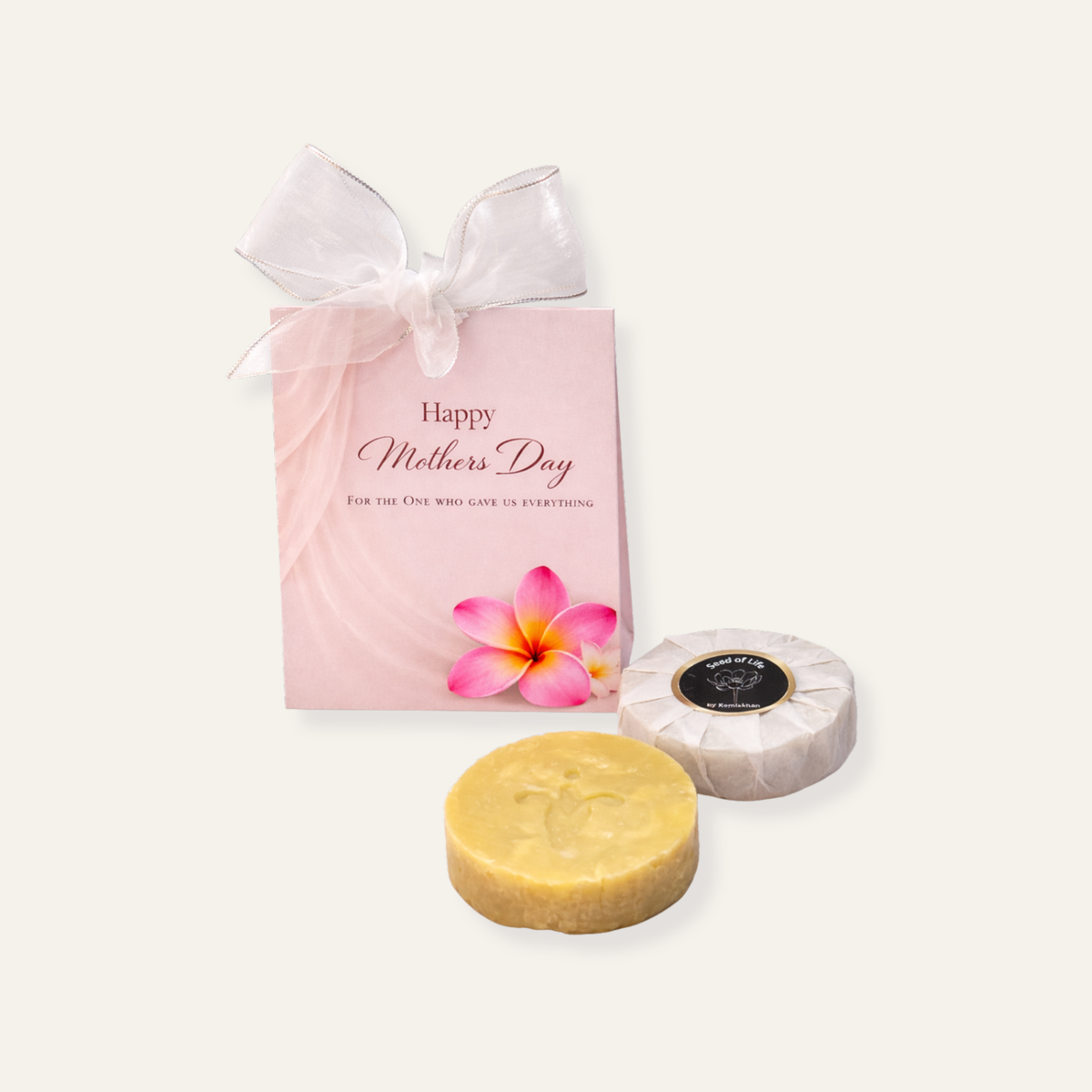 Two soaps and a 'Happy Mother's Day' gift bag with a pink flower on a white background