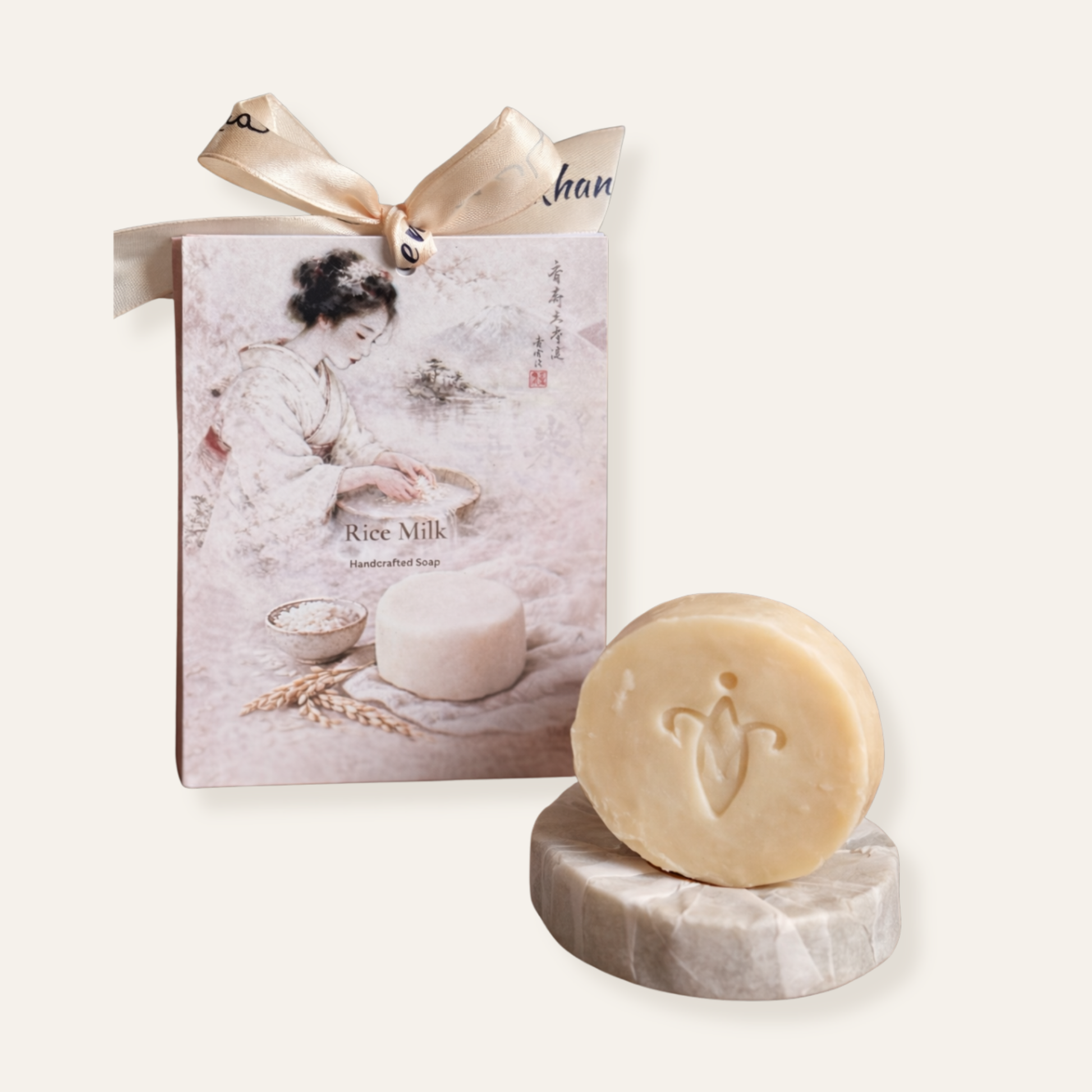 Bar of rice milk soap with packaging on a white background