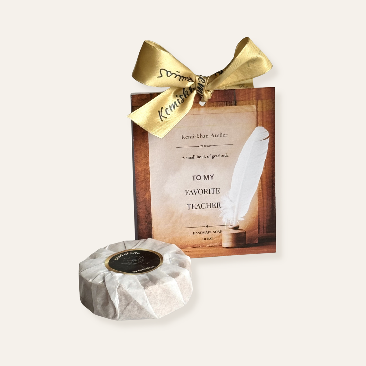 Gift box for Teachers with gold bow and feather design, featuring a small round soap on a white background.